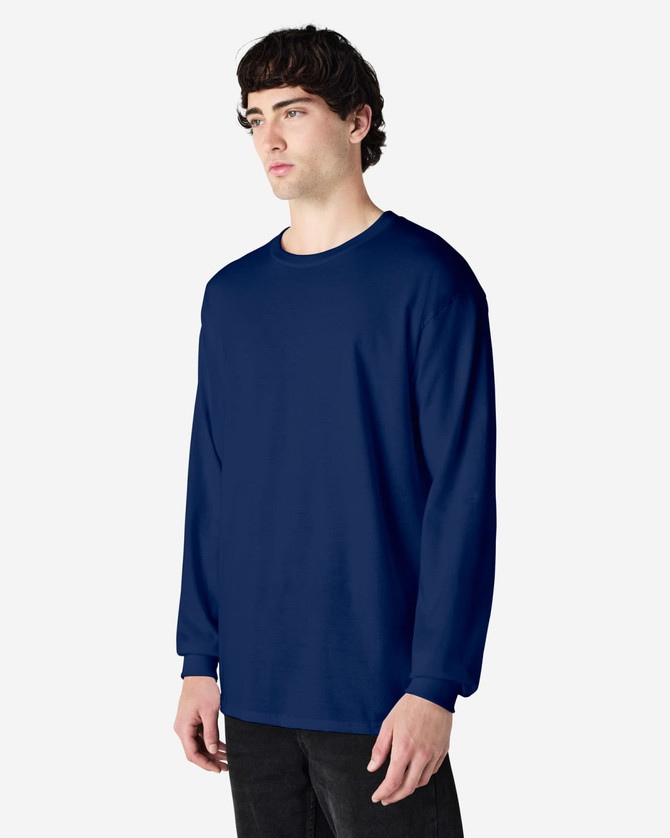 A navy long sleeve t-shirt on a model, featuring a round neckline and a simple design. The shirt has a logo.