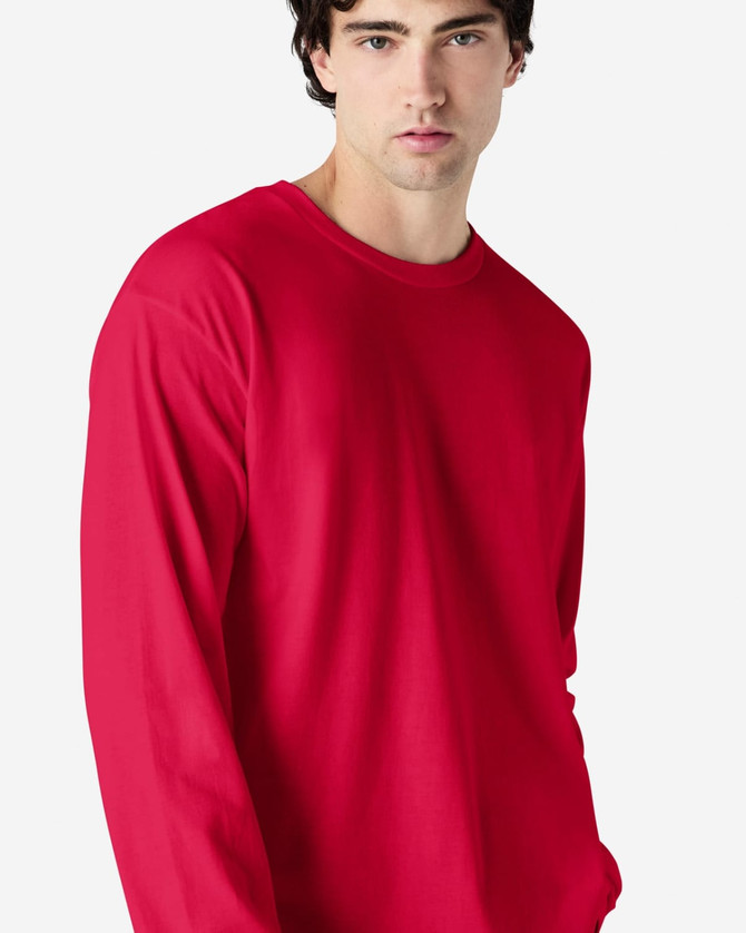 A red long sleeve t-shirt with a relaxed fit, featuring a logo on the front.