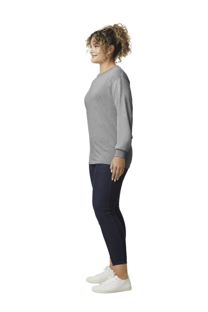 A long sleeve grey t-shirt displayed on a model wearing dark pants and white sneakers, featuring a logo.
