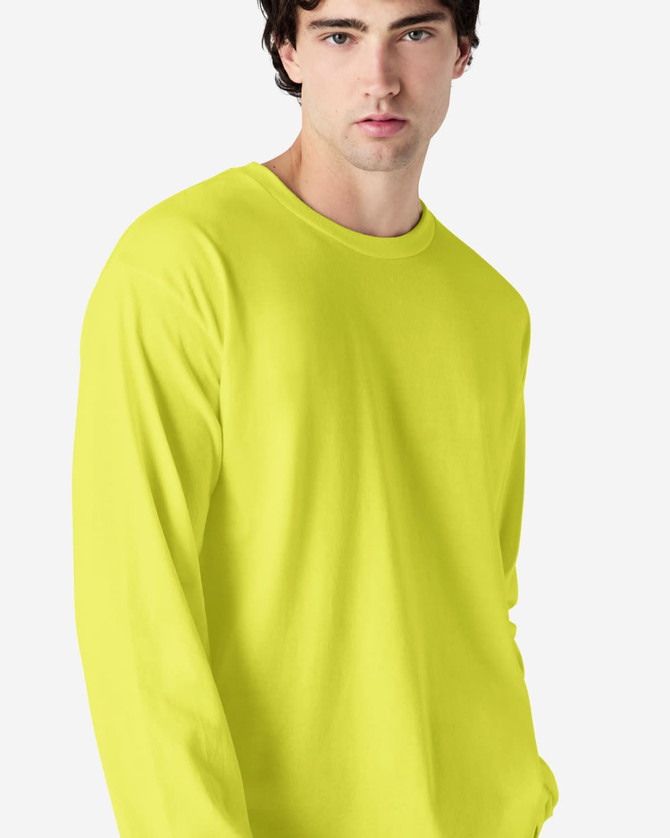 A bright yellow long sleeve t-shirt with a relaxed fit. It features a logo on the front.