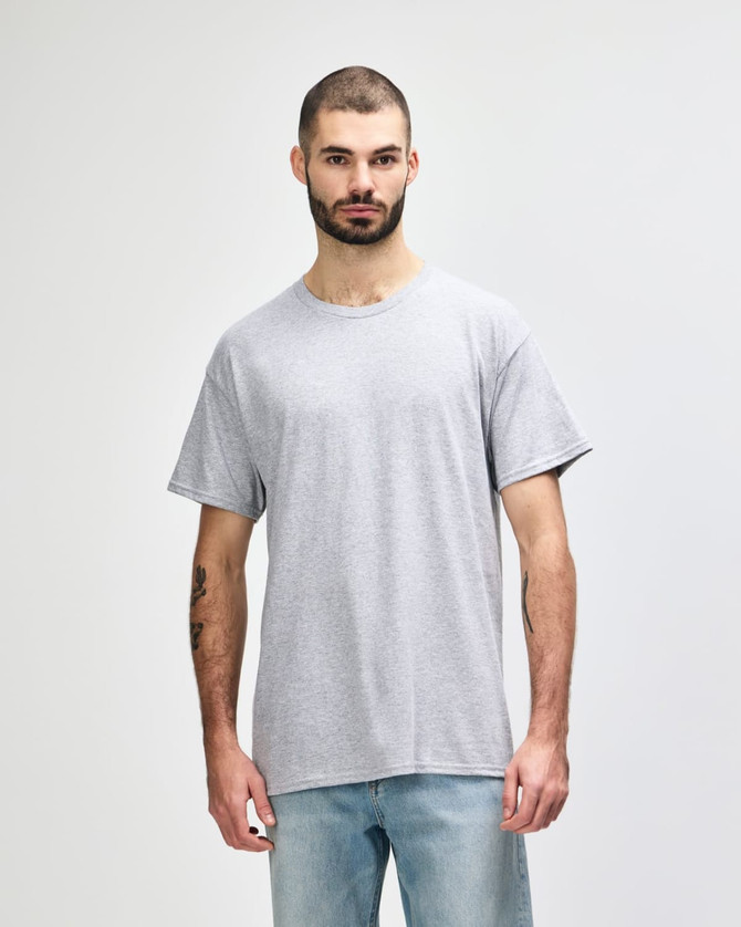 A grey T-shirt with a relaxed fit, featuring a logo on the front, displayed on a male model.