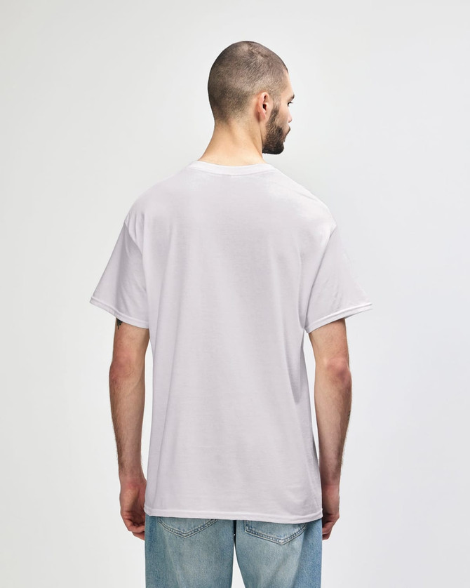 A man wearing a light grey Gildan Heavy Cotton Adult T-Shirt, viewed from the back. The shirt has a logo.