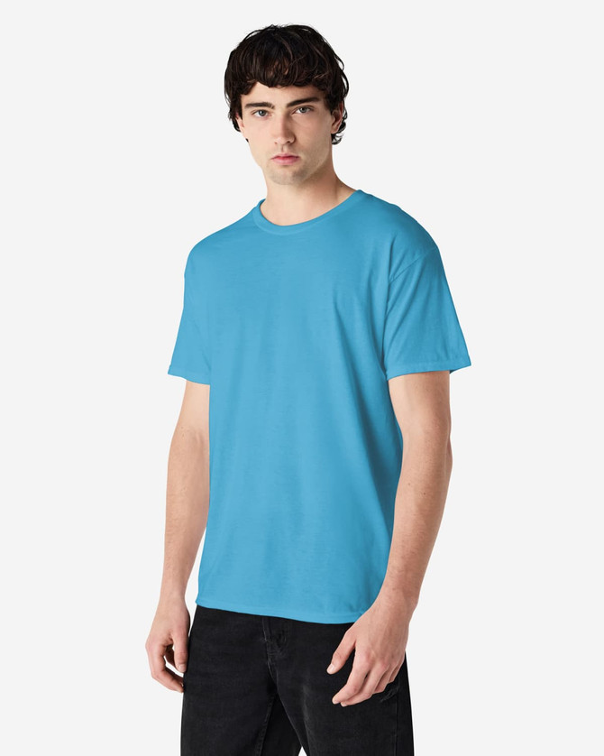 A model wearing a bright blue Gildan Heavy Cotton adult T-shirt, featuring a plain design and a logo on the chest.