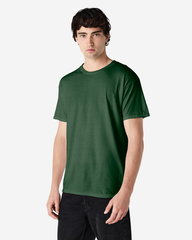 A green Gildan Heavy Cotton Adult T-Shirt displayed on a model, featuring a logo on the front.