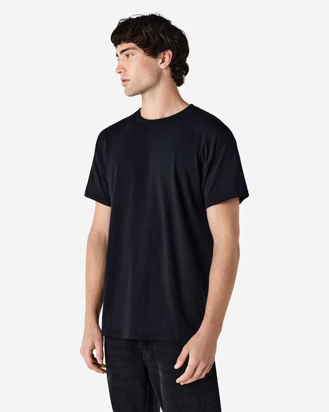 A black Gildan Heavy Cotton Adult T-Shirt displayed on a male model, featuring a simple logo.