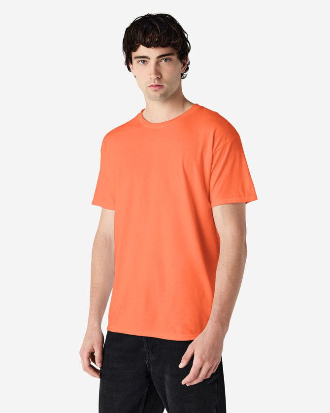 An orange Gildan Heavy Cotton adult T-shirt displayed on a male model. The shirt has a simple design and features a logo.