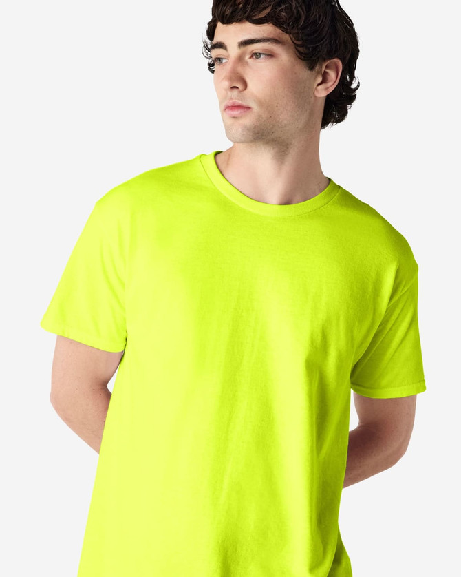 A bright yellow Gildan Heavy Cotton Adult T-Shirt is displayed on a model with short dark hair.