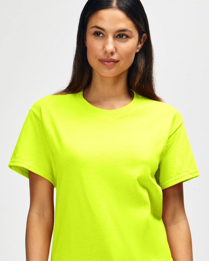 A bright yellow Gildan Heavy Cotton Adult T-Shirt is displayed on a model with short dark hair.