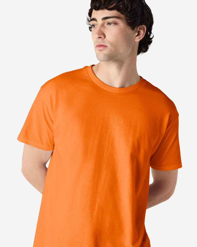 An orange Gildan Heavy Cotton adult T-shirt displayed on a model, featuring a classic fit and crew neckline.