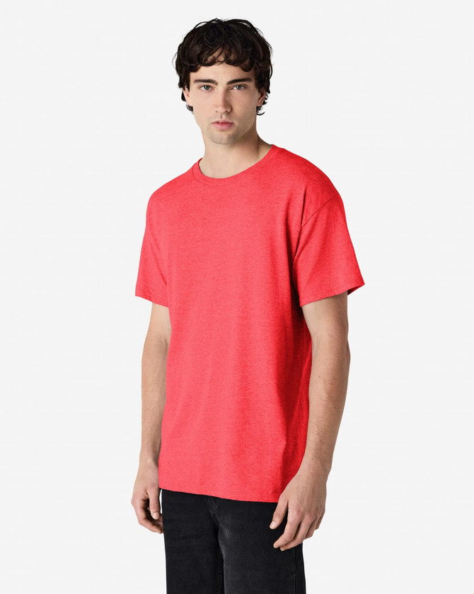 A red Gildan Heavy Cotton Adult T-Shirt displayed on a model, featuring a simple design and a casual fit.