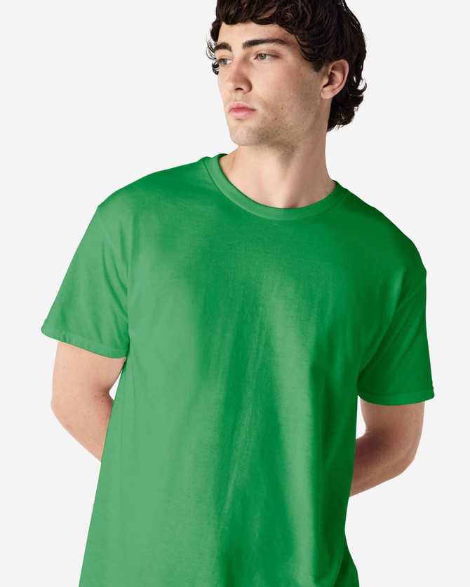 A green Gildan Heavy Cotton Adult T-Shirt displayed on a model, featuring a simple design and a logo.