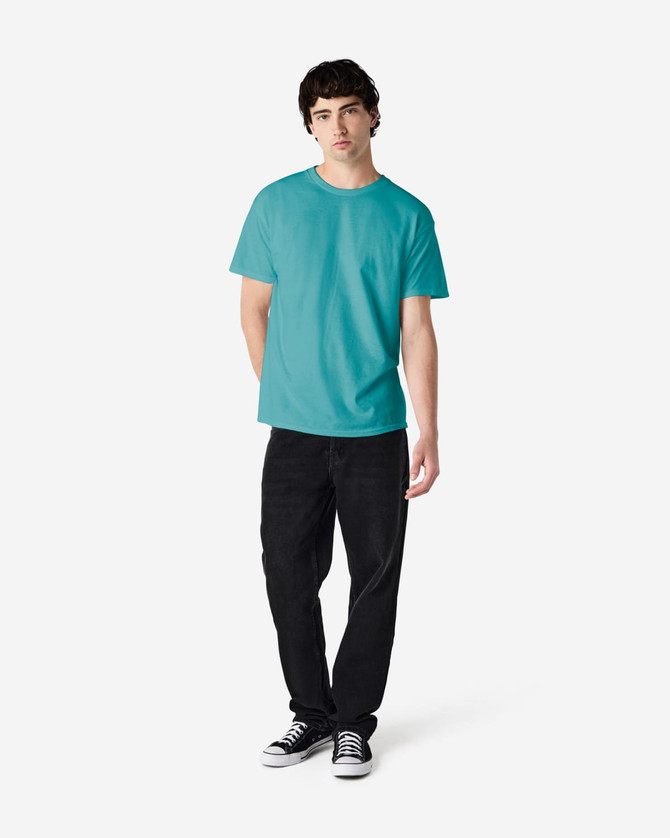 A turquoise Gildan Heavy Cotton Adult T-Shirt displayed on a male model, paired with black jeans and sneakers.