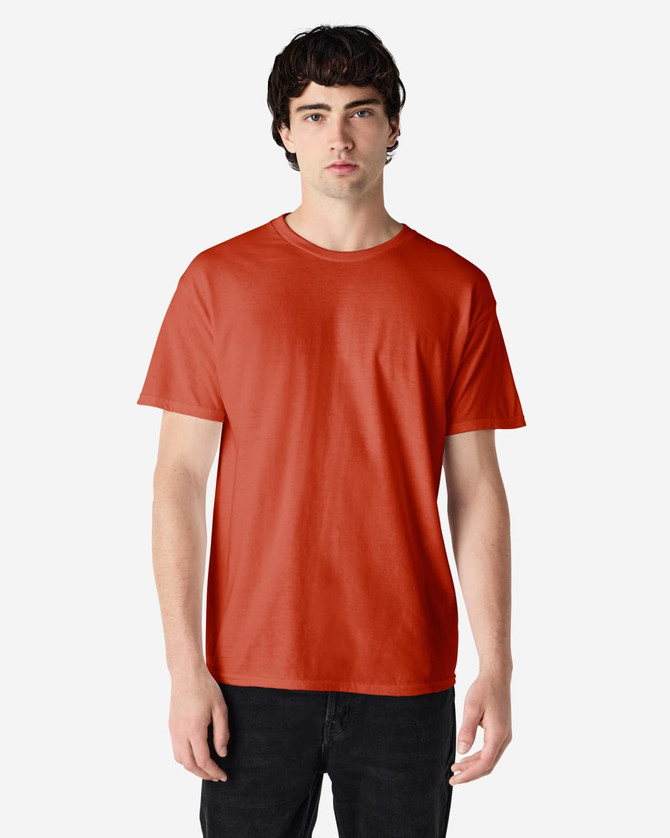 A plain orange adult t-shirt featuring a round neck and short sleeves, displayed on a model.