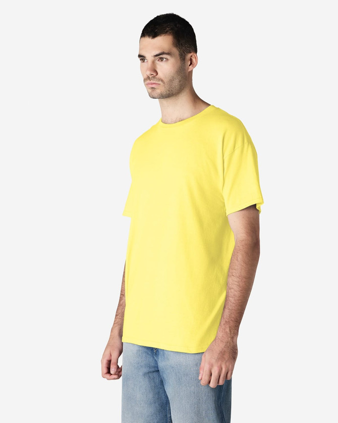 A yellow Gildan Heavy Cotton Adult T-Shirt displayed on a model, featuring a simple design and a relaxed fit.