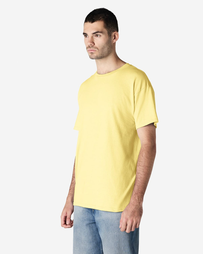 A yellow Gildan Heavy Cotton Adult T-Shirt displayed on a model, featuring a simple design and a logo.