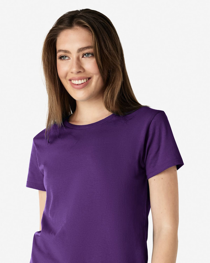 A purple Gildan Heavy Cotton Ladies' T-Shirt displayed on a smiling woman, featuring a round neck and short sleeves.