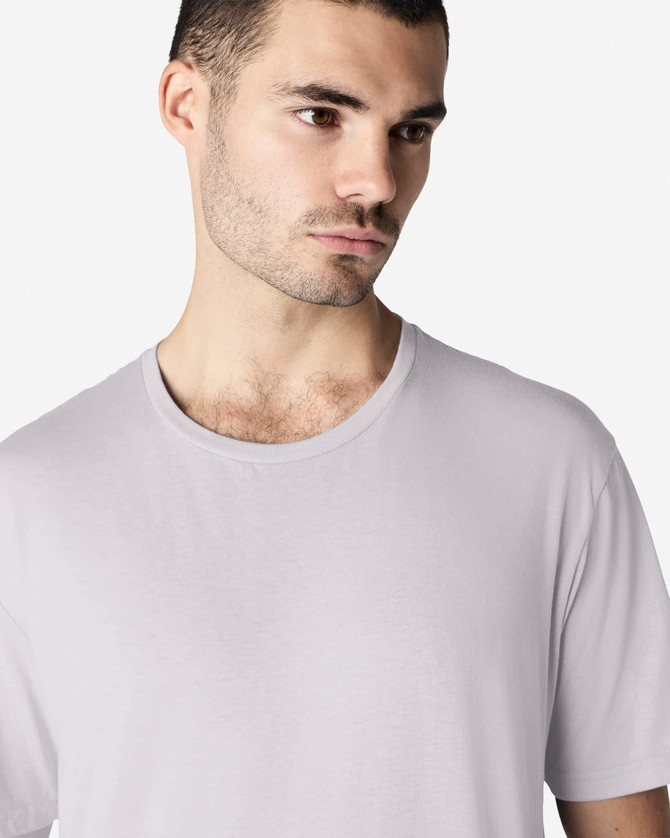 A light grey Gildan Softstyle adult t-shirt with a round neckline displayed on a male model. It features a brand logo.
