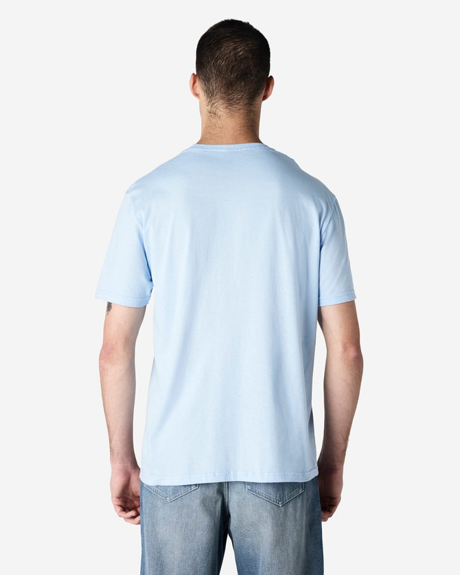 A light blue Gildan Softstyle adult t-shirt viewed from the back, featuring a simple design and a branding logo.