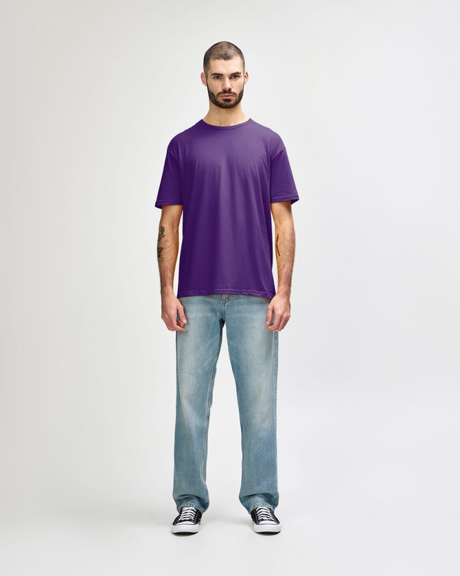 A purple Gildan Softstyle adult t-shirt displayed on a mannequin paired with light blue jeans and white shoes.