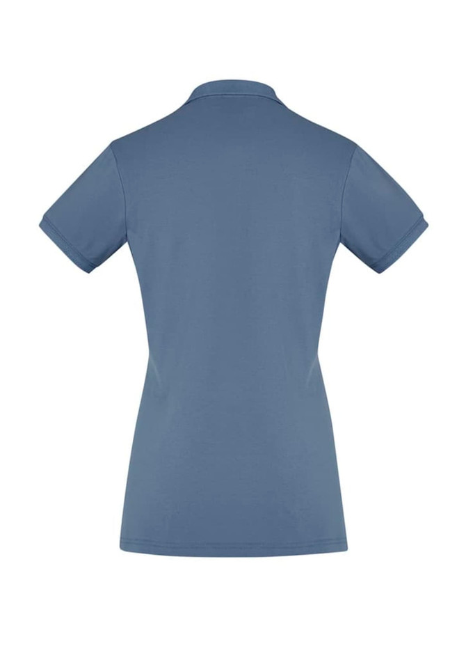A women's short sleeve polo shirt in a soft blue colour with a simple design and a collar. It has a logo.