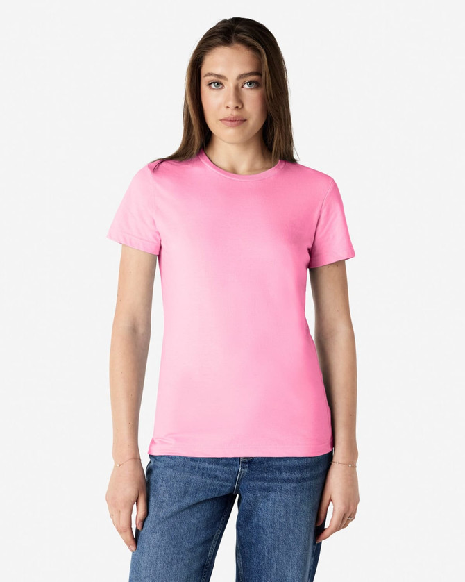 A pink Gildan Softstyle ladies' T-shirt on a model, featuring a classic crew neck and short sleeves.