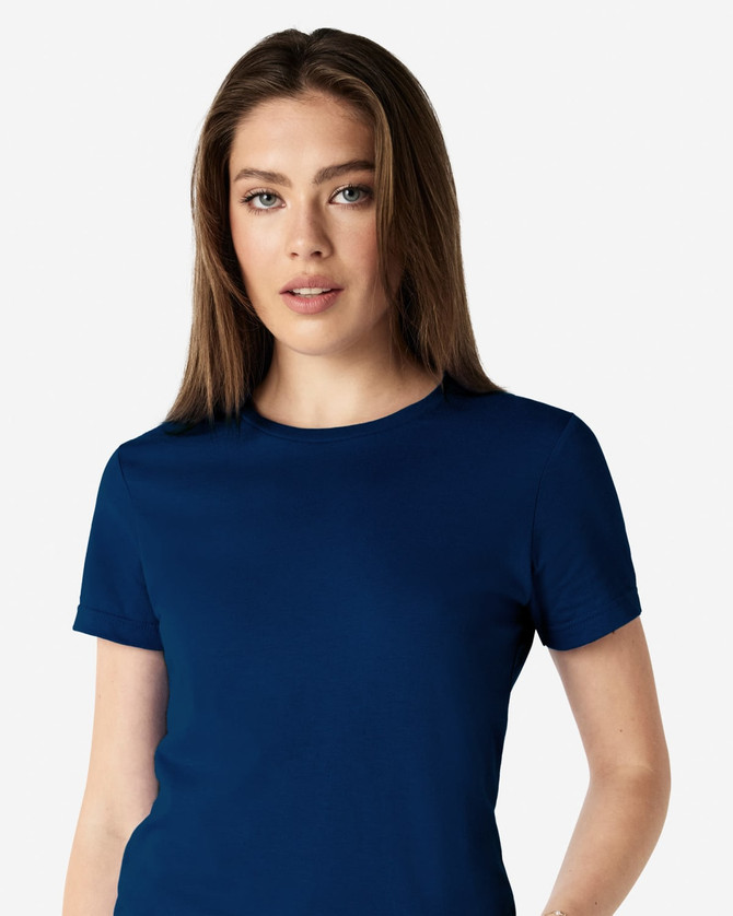 A navy Gildan Softstyle ladies' t-shirt displayed on a model, featuring a simple design and short sleeves.