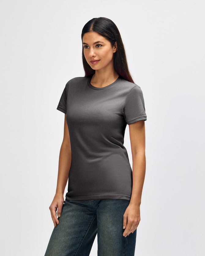 A grey Gildan Softstyle ladies' t-shirt displayed on a model, featuring a fitted design and short sleeves.