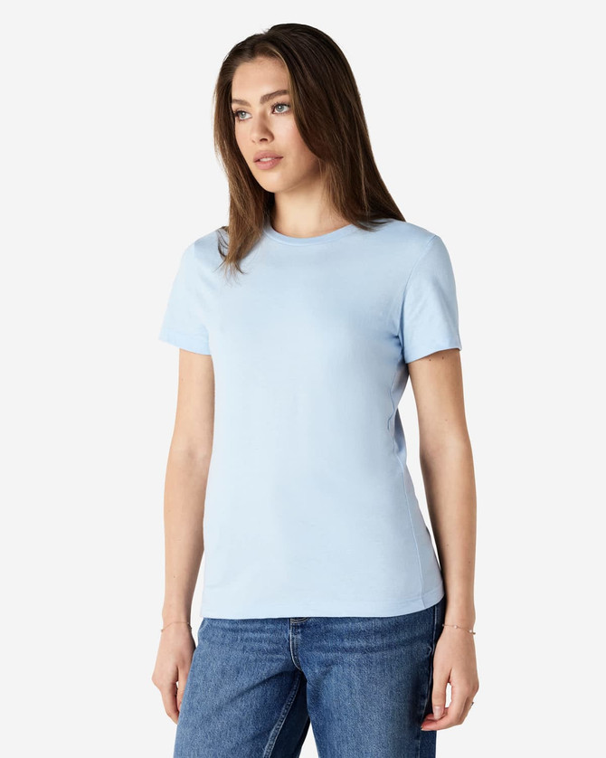 A light blue Gildan Softstyle ladies' T-shirt displayed on a model, featuring a round neckline and short sleeves.