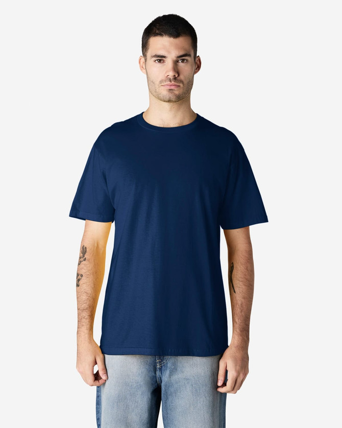 A navy blue midweight t-shirt on a model, featuring a simple design and a logo on the front.