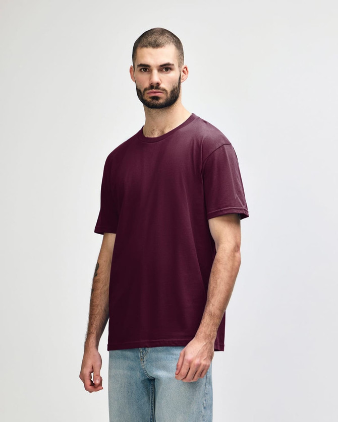 A burgundy Gildan Softstyle Adult Midweight T-Shirt displayed on a model, featuring a branding logo.