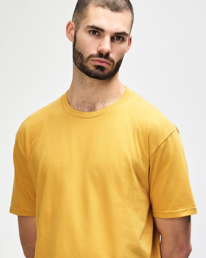 A midweight adult t-shirt in a mustard yellow colour, featuring a crew neck and short sleeves. It has a logo.