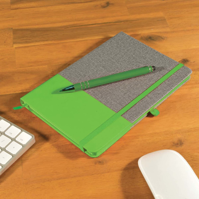 A notebook with a gray cover and green accents, accompanied by a matching green pen, placed on a wooden desk.