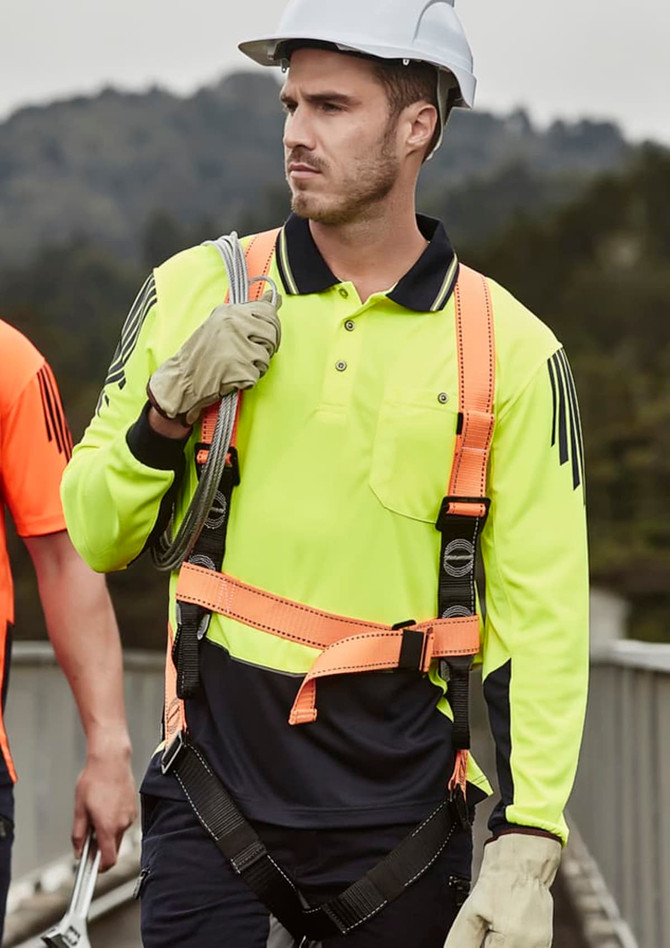 A long sleeve polo in high visibility yellow with navy accents, featuring safety gear and a helmet. Includes a logo.