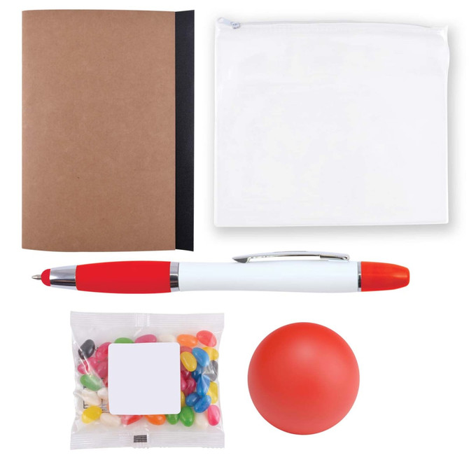 A notebook, a zippered pouch, a red and white pen, a bag of multicolored candies, and a red stress ball.
