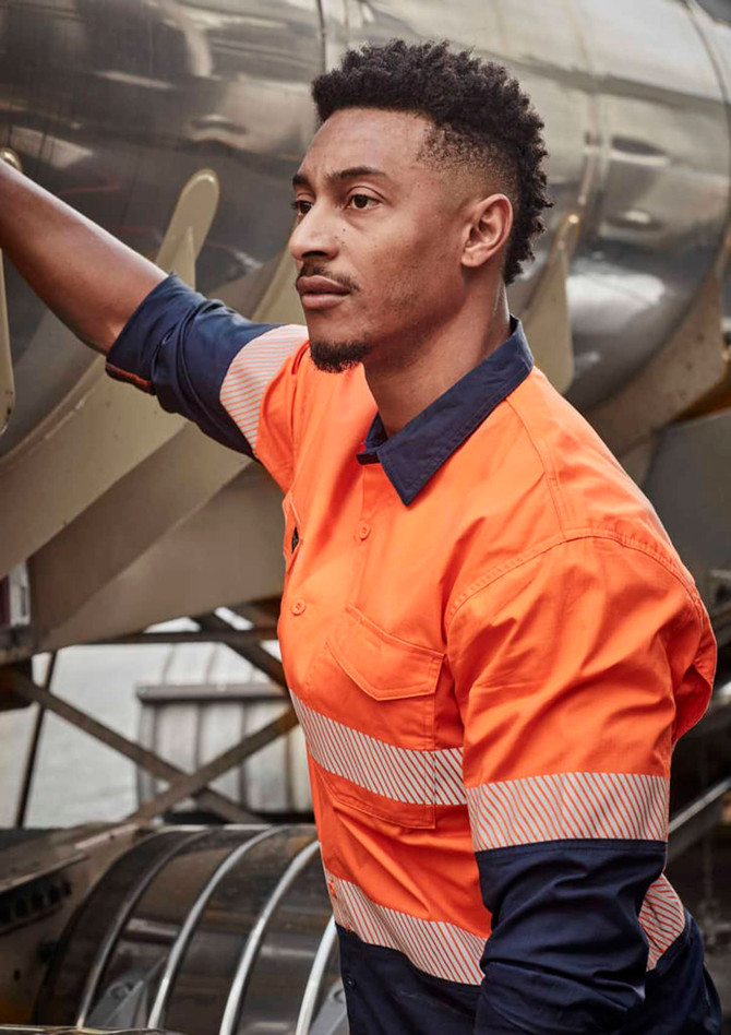 A long sleeve work shirt in orange and navy with segmented reflective tape, featuring a logo on the chest.