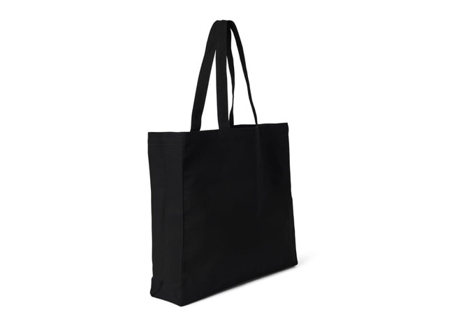 A black heavy tote bag with long handles and a simple design. It features a logo on one side.