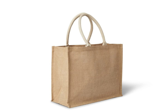A natural jute bag with two cream-coloured handles, featuring a simple, unbranded design.