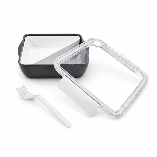 A square, black and white lunch box with a clear lid and a white fork. The lid has a vent.