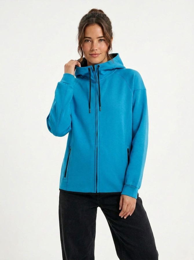 A grey hoodie made of soft cotton and bonded polar fleece, featuring a hood and zippered pockets.