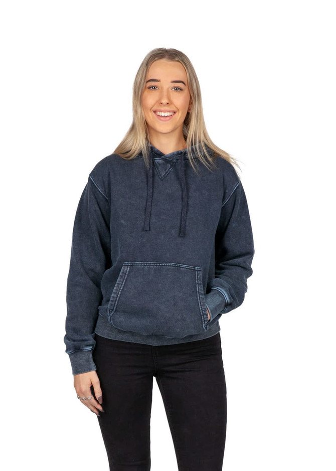 A woman wearing a navy stone wash fleece hoodie, featuring a kangaroo pocket and drawstrings.
