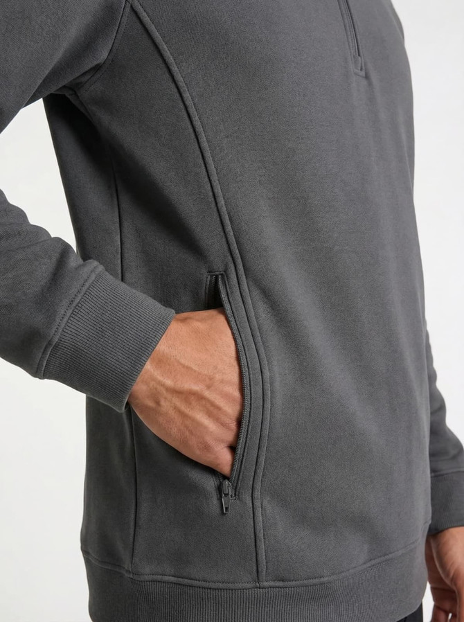 A grey men's half zip fleece jumper featuring side pockets. The fabric appears soft and lightweight.