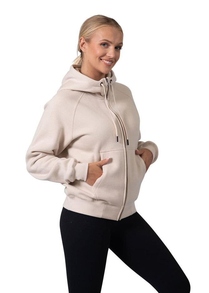 A women's cotton hoodie in light beige with a kangaroo pocket and a zipper, featuring a logo on the hood.