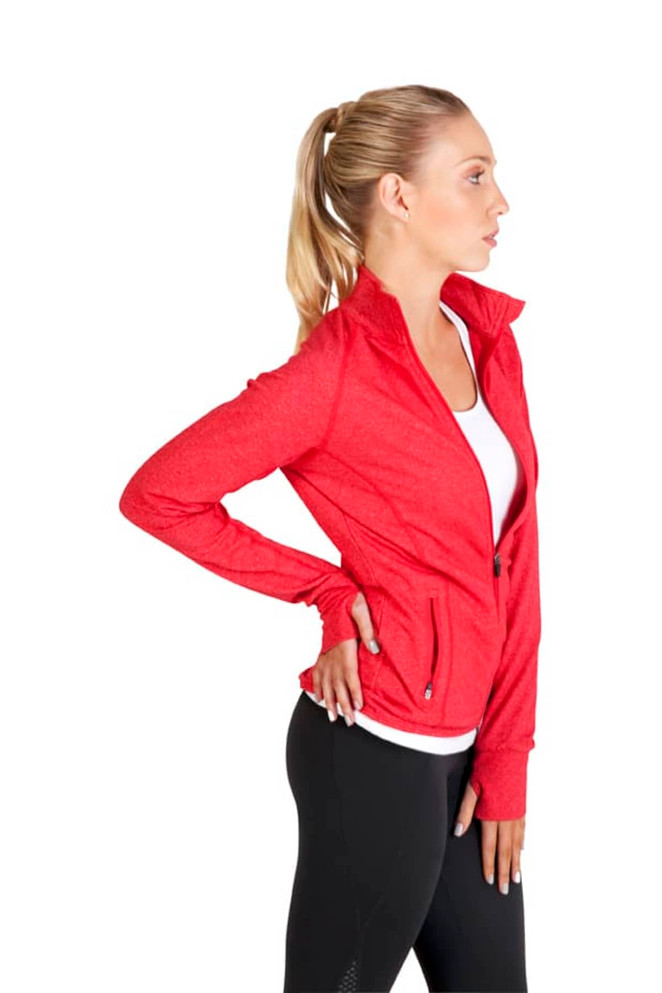 A woman in a red heather jacket, paired with black leggings, standing with one hand on her hip. The jacket features a logo.