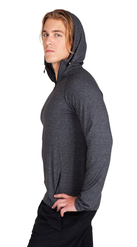 A male model wearing a grey half-hood top, featuring a fitted style and a hood. The top has a logo.
