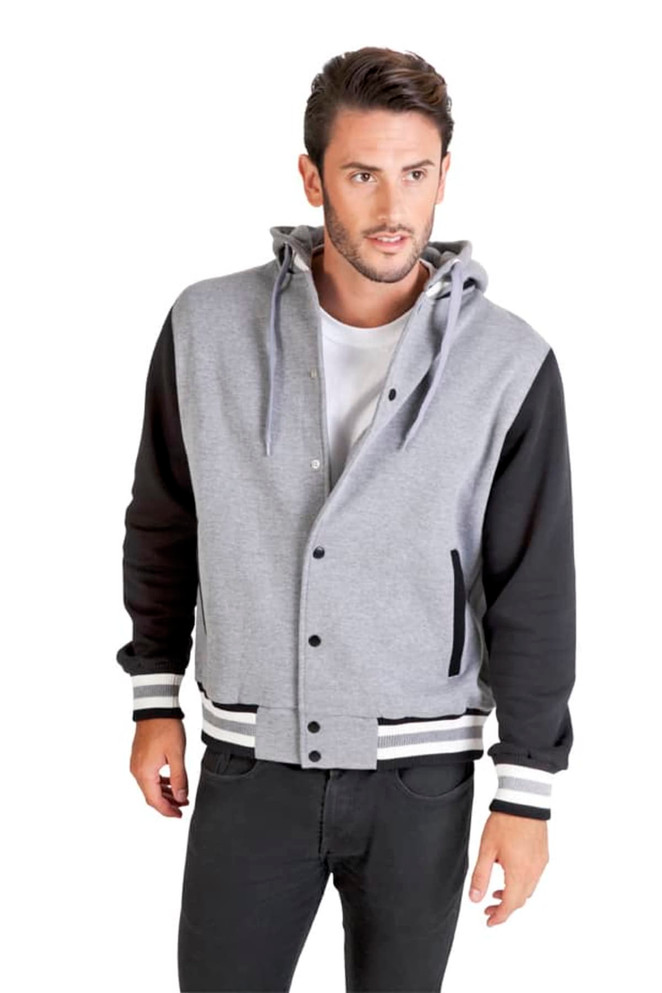 A men's varsity jacket in grey with black sleeves, featuring a hood and striped cuffs. The model is wearing it casually.