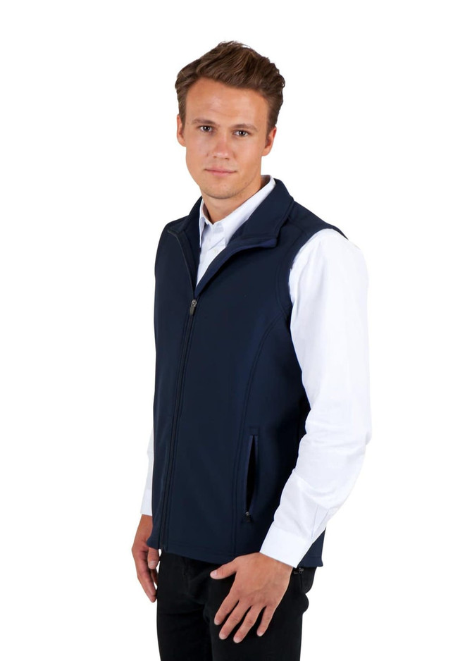 A navy men's soft shell vest from the TEMPEST range, featuring a zip and side pockets, worn over a white shirt.
