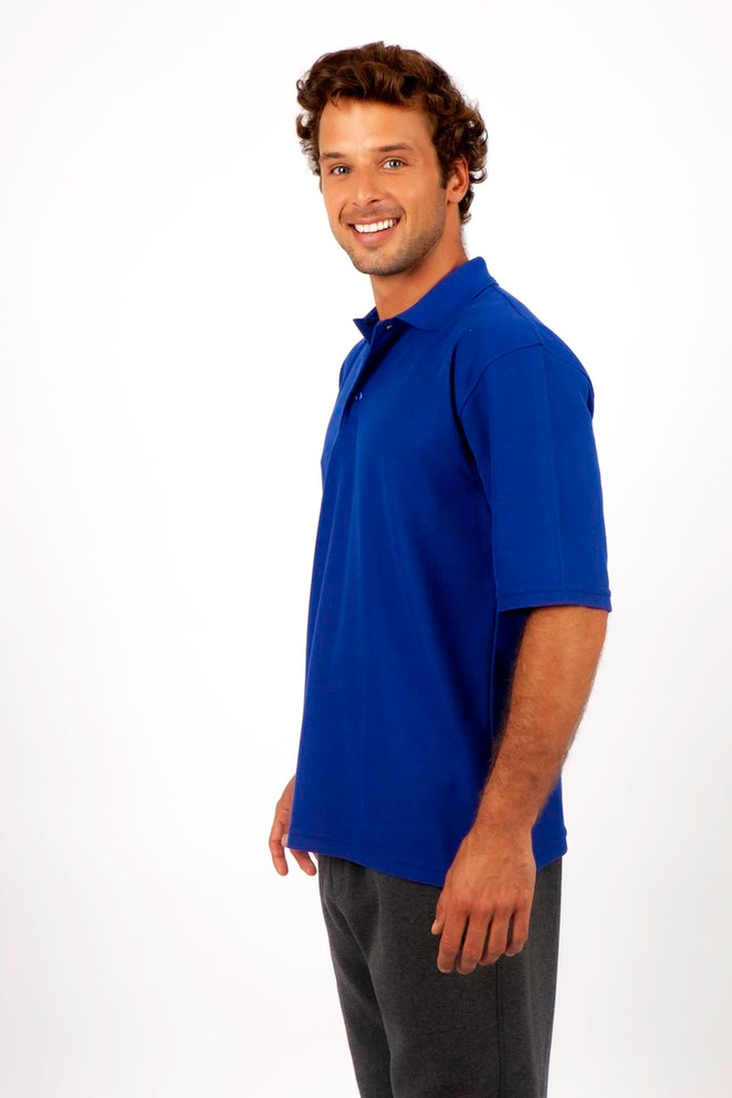 A man wearing a blue regular pique knit polo shirt, smiling and standing sideways on a plain background.