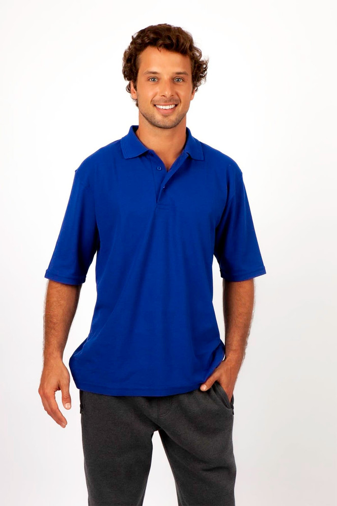 A man wearing a blue regular pique knit polo shirt, featuring a logo, and dark grey trousers.