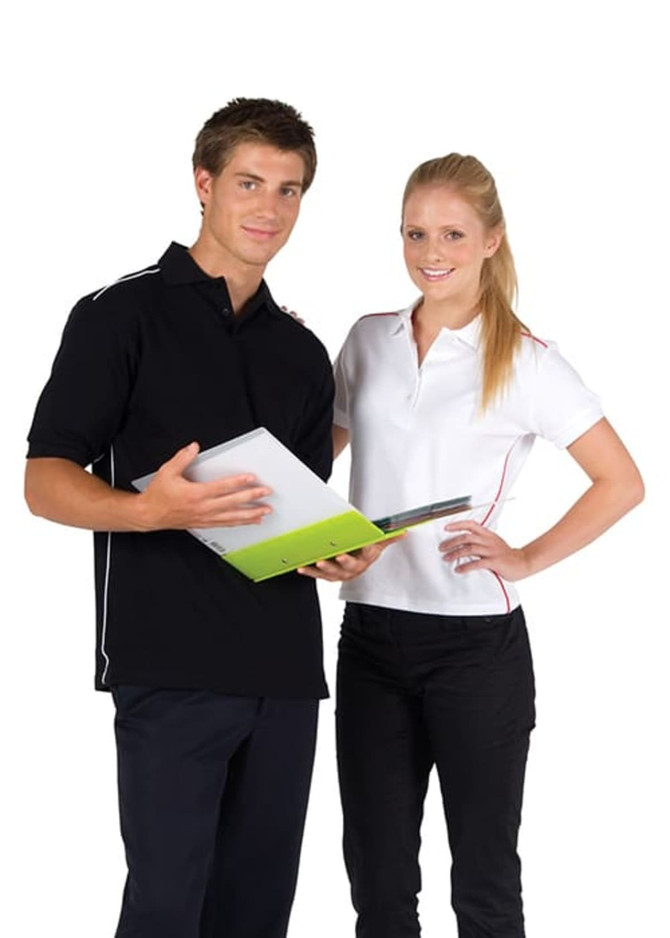 A man in a black polo shirt and a woman in a white polo shirt, both with contrasting piping, holding a folder.
