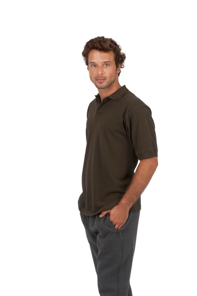 Men's cotton pigment dyed polo in dark green, featuring a collar and short sleeves, displayed on a model.